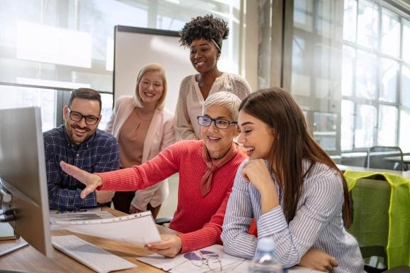Office workers smiling at a desk