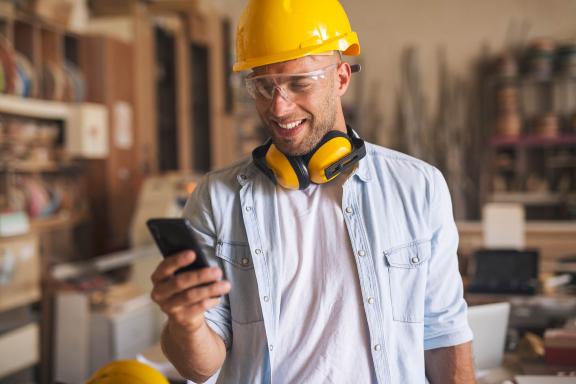 A worker holding a mobile phone
