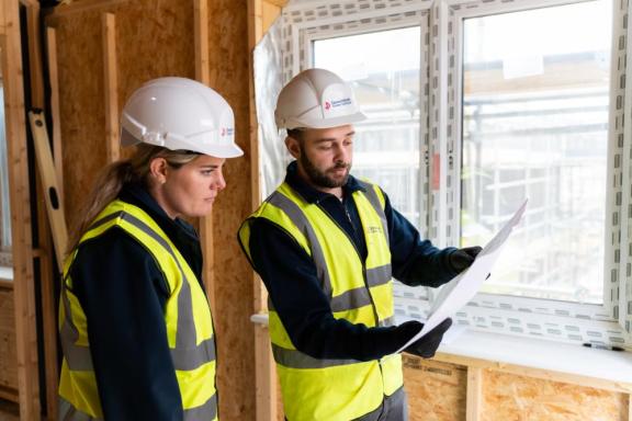 Two builders looking at a plan.
